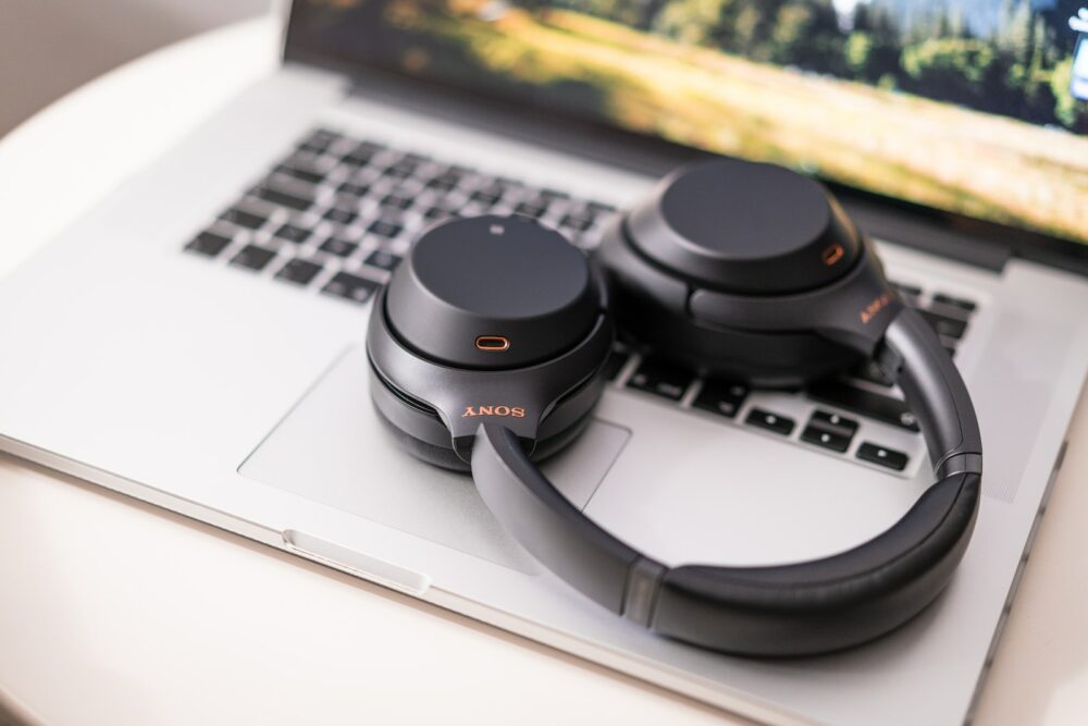 black and gray sony headphones on macbook pro